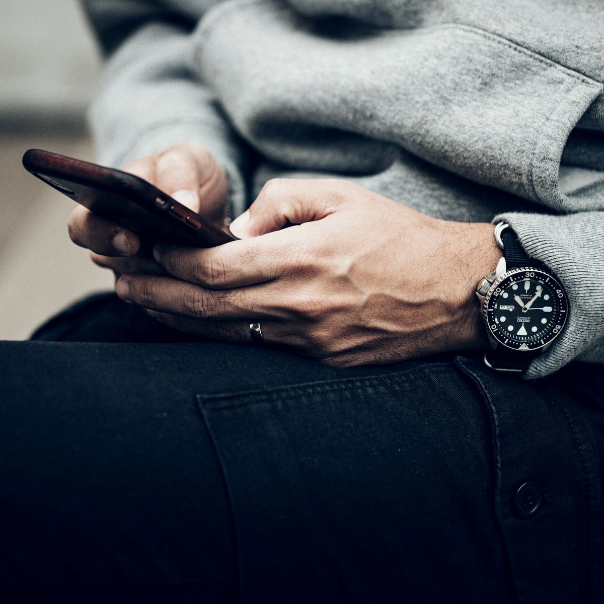 Person reading reviews on a phone before choosing a firm