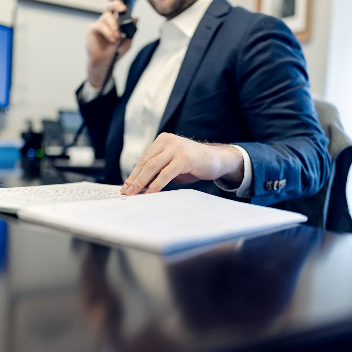 Attorney taking a follow-up call at an office desk